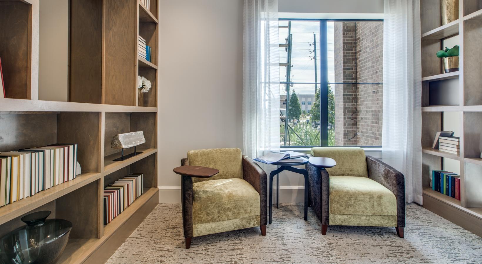 The essence of exceptional living a room with a table chairs and a bookcase