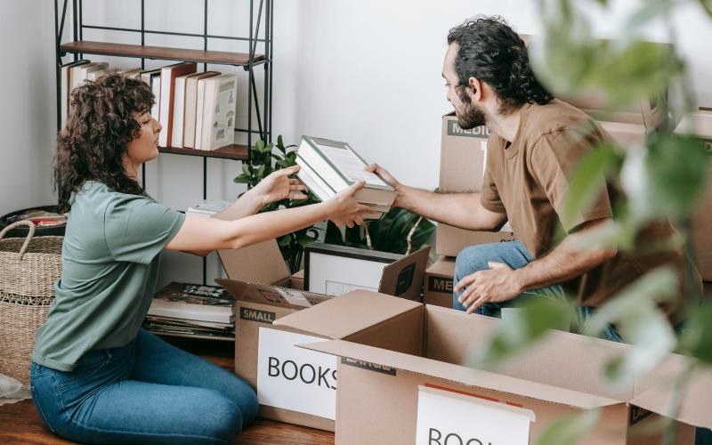 a man and a woman sitting on boxes