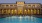 a large building with a pool in front of it